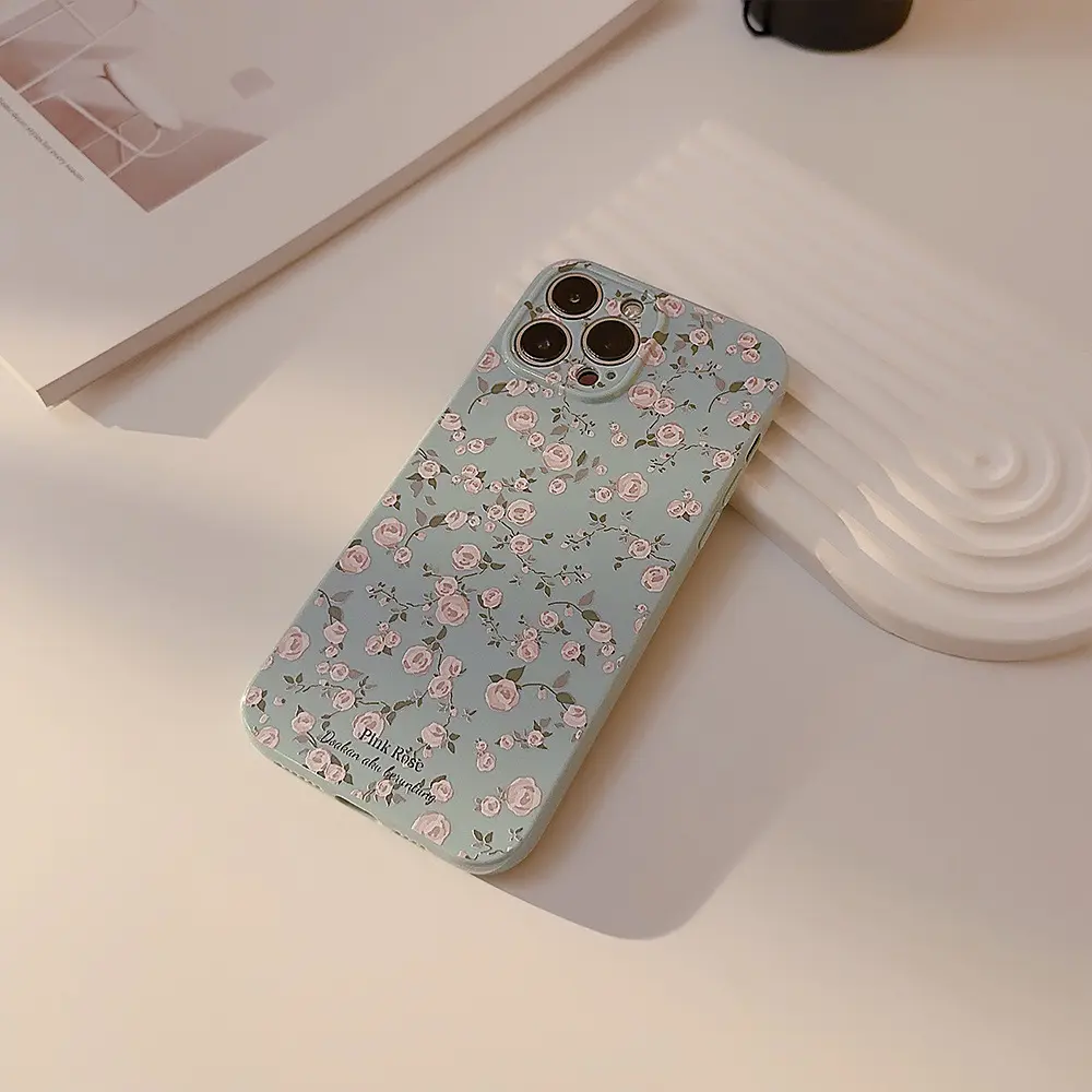 Vintage floral phone case on a cream tabletop